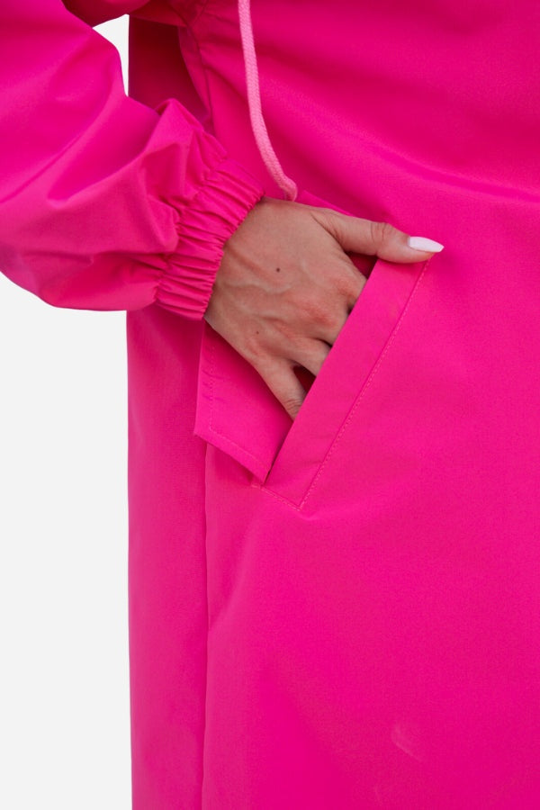 Close-up of hand in pocket of vibrant Barbara Pink Raincoat windbreaker jacket with elastic cuff detail