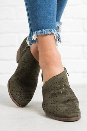 Laser cut western ankle boots in olive green with low heels and zipper detail on side.