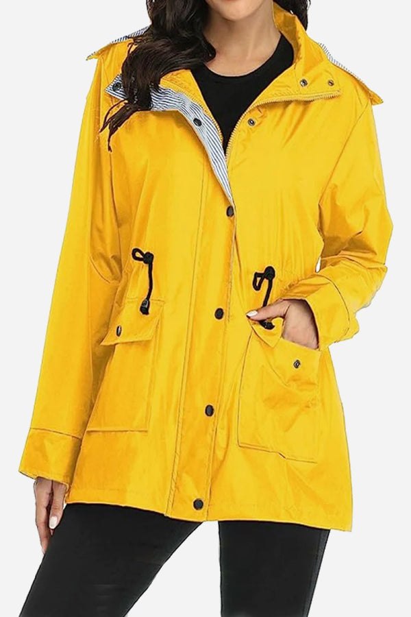 Women's yellow water resistant hooded windbreaker jacket with striped inner lining and front pockets