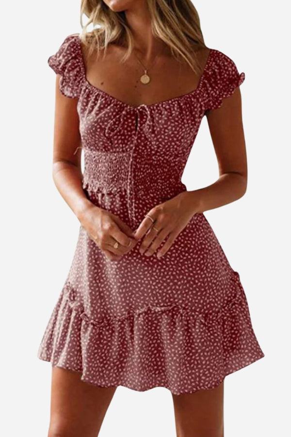 Woman wearing a red sweetheart collar printed ruffled maxi dress with short sleeves and a high waist design