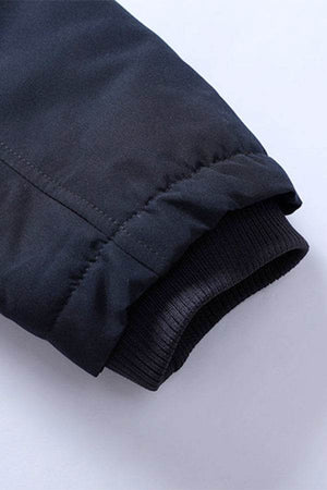 Close-up of sleeve cuff on thick long-sleeve zipper overcoat showing durable fabric and elastic ribbing detail