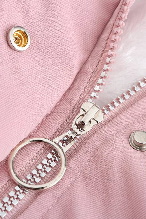 Close-up of pink thick long-sleeve zipper overcoat with silver ring zipper pull and snap button detail