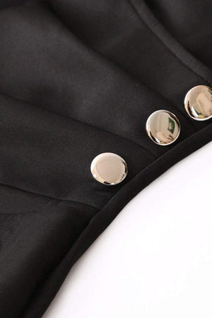 Close-up of stylish button pencil dress with gold buttons on black fabric