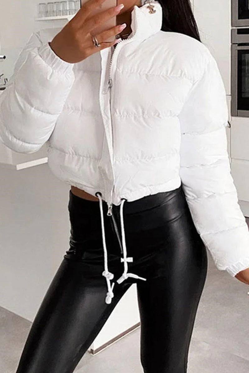 White sleek cropped puffer jacket with high collar and drawstring hem, styled with black pants.