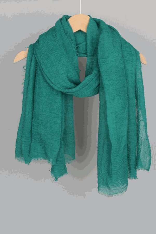 Green linen Color-POP Scarf hanging on wooden hanger, lightweight and breathable, all-weather ready, eco-friendly fabric.
