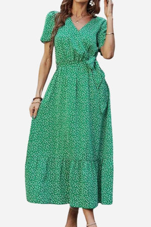 Charming Floral Boho Maxi Dress in green with white floral print, wrap V-neck, belted waist, and ruffle hem.