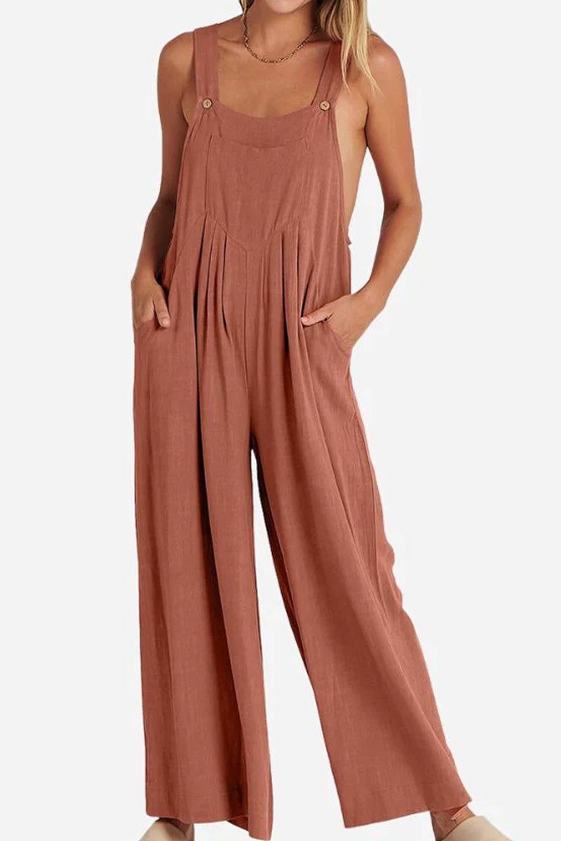 Woman wearing rust-colored Free-Flow Wide Leg Overalls made of breathable cotton blend fabric