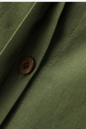 Close-up of olive green relaxed shirt fabric with button detail from two-piece set