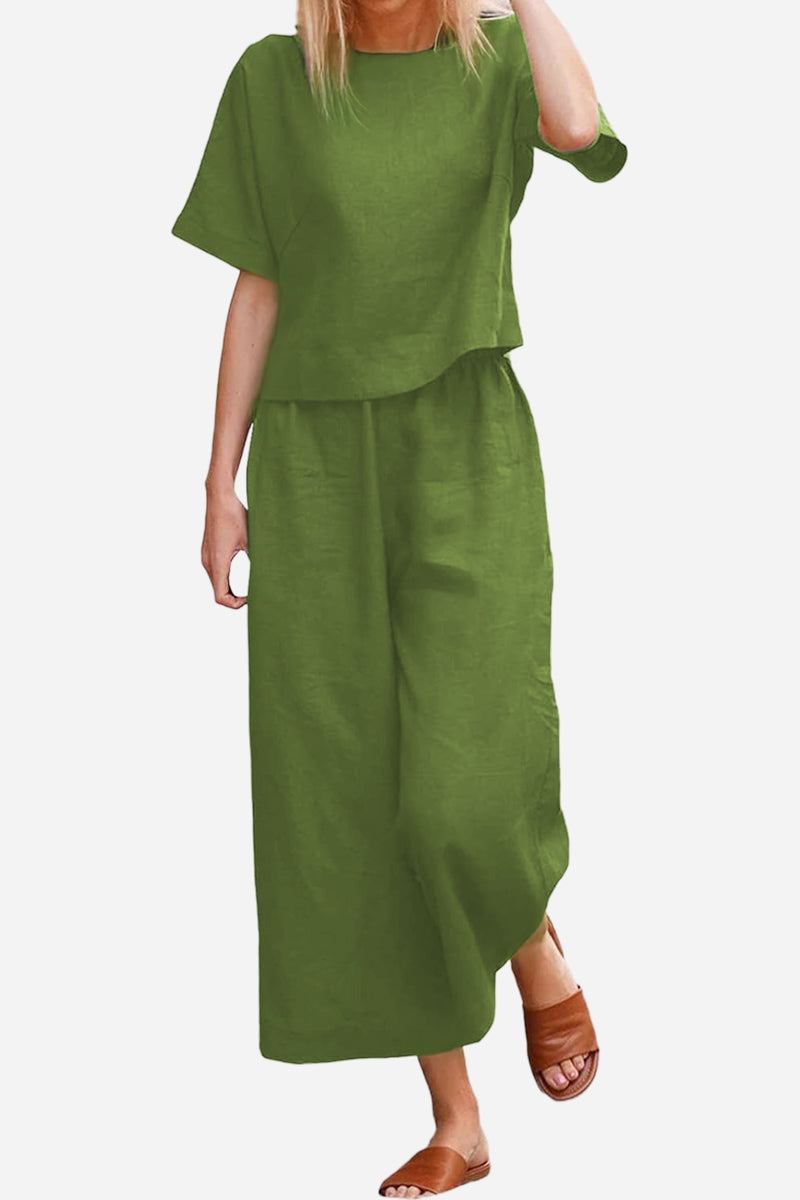 Woman wearing olive green loose fit co-ord set with wide-leg pants and short-sleeve top