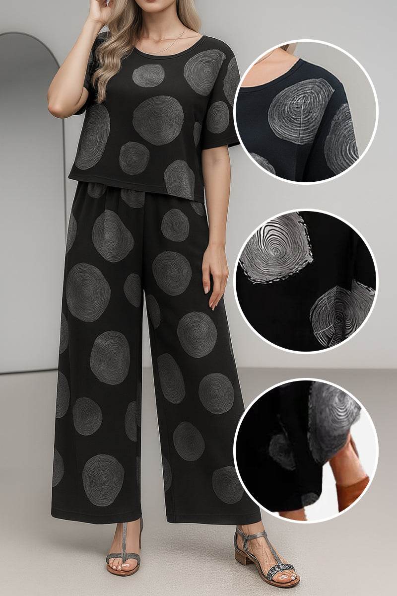 Black loose fit co-ord set with wide-leg pants and short-sleeve top featuring large gray circular patterns