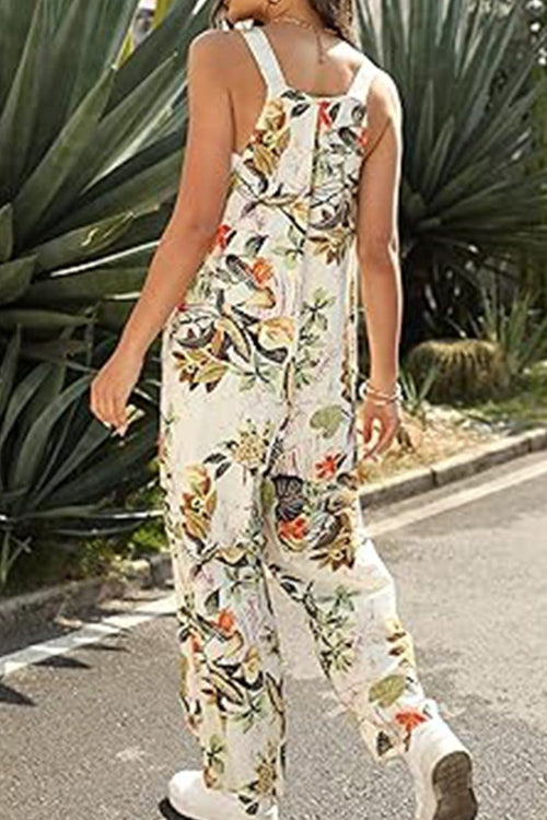 Woman wearing floral Bohemian Fantasy Overalls walking outdoors beside greenery