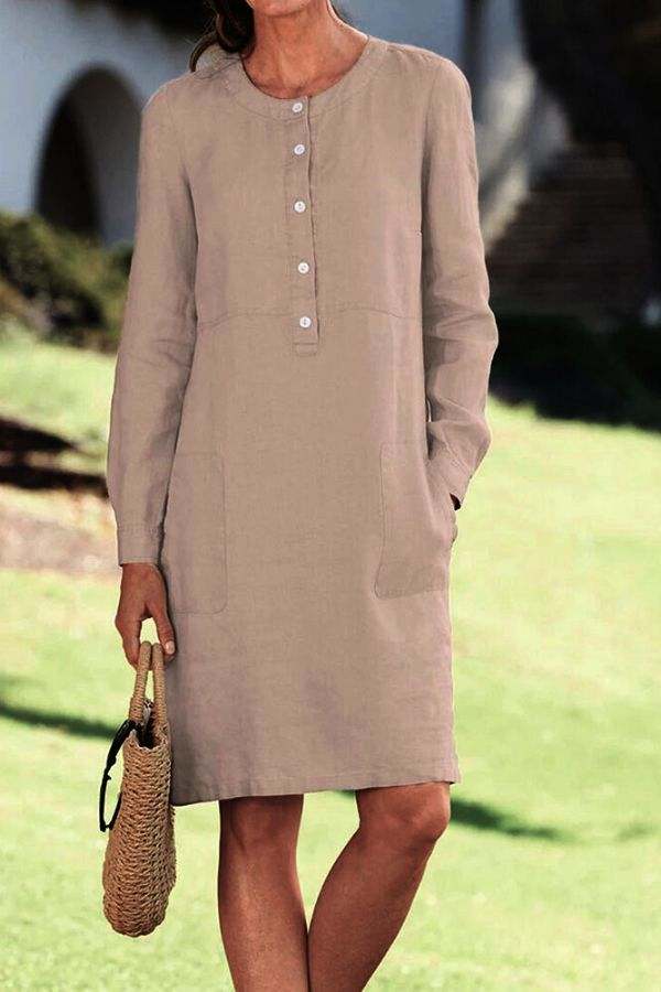 Lightweight khaki cotton dress with half-button front and long sleeves, casual knee-length design with pockets.