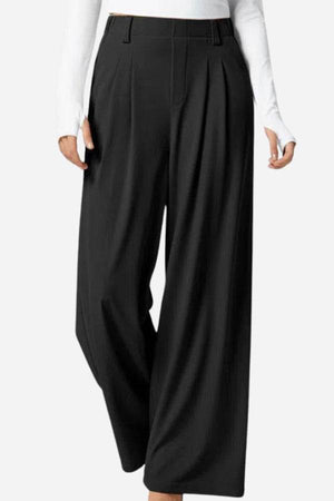 High-waisted plicated wide leg waffle pants in black with pleated design and wide-leg silhouette for a sleek, elegant look.