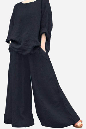 Black wide leg pants with pockets paired with loose black top, bohemian style outfit