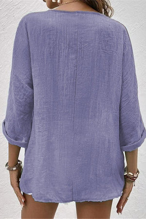 Back view of a lavender breezy button front tunic with rolled sleeves and crinkled bohemian fabric style