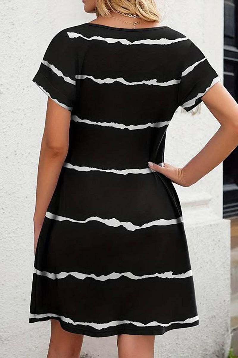 Back view of a black short-sleeved pleated dress with white horizontal stripes and a modest knee-length cut