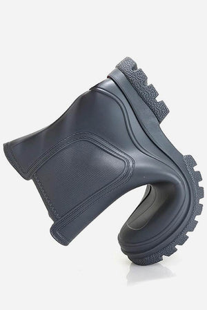 Folded black non-slip rain boot with textured SuperGrip sole and waterproof design