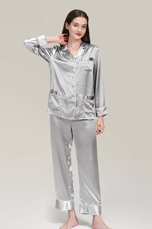 Woman wearing silver long sleeve silk pajamas button-up top and matching pants
