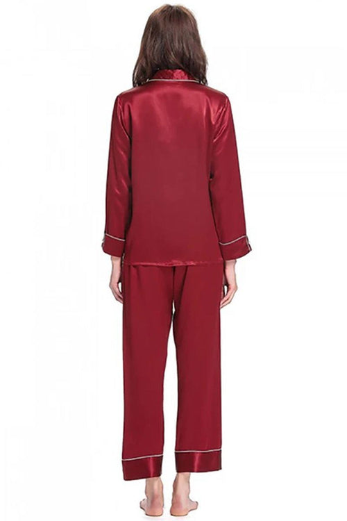 back view of woman wearing long sleeve silk pajamas set in deep red mulberry silk with button-up top and matching pants