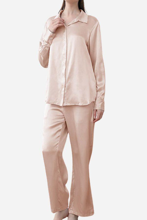 Woman wearing classic beige Mulberry silk sleepwear set with long sleeves and pants