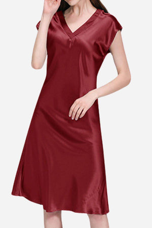 Woman wearing a burgundy Mulberry Silk V-Neck Nightgown with short sleeves and flowing silhouette.