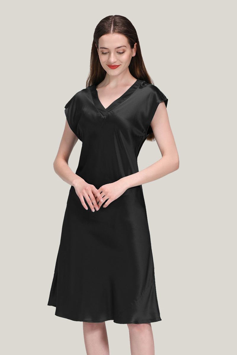 Woman wearing black Mulberry Silk V-Neck Nightgown with short sleeves on beige background