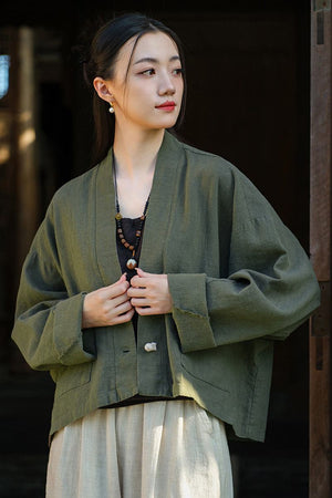Woman wearing one size fits all ramie linen and cotton cardigan in olive green with relaxed fit and open front design