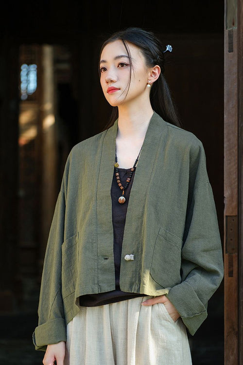 Woman wearing an olive green one size fits all ramie linen and cotton cardigan with relaxed fit and open front design.