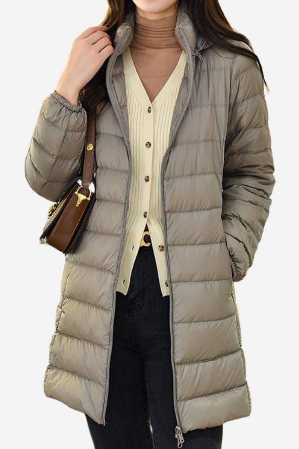 Lightweight water-resistant hooded puffer coat for women with long sleeves and a sleek design