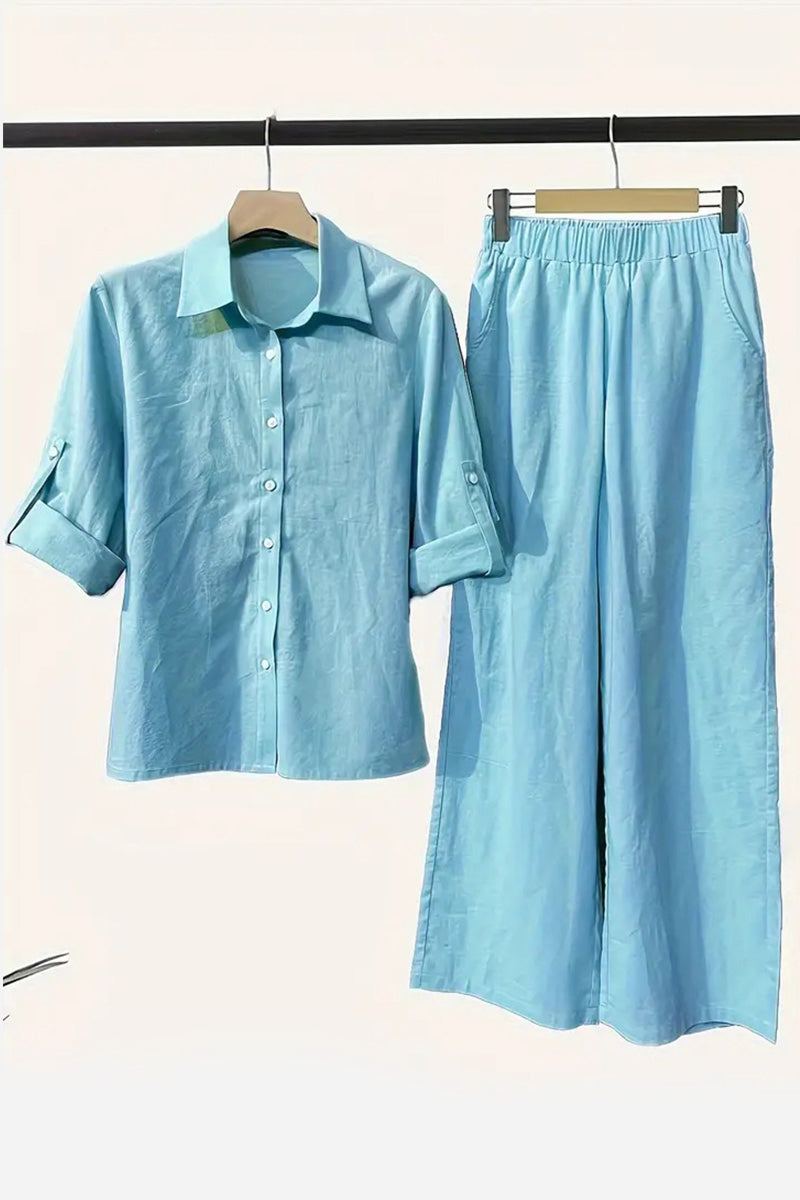 Light blue cotton blend two-piece set with button-up shirt and elastic waist pants hanging on wooden hangers