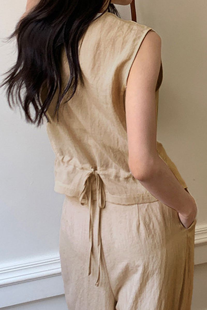 Woman wearing eco chic linen blend beige sleeveless two-piece outfit with drawstring back detail