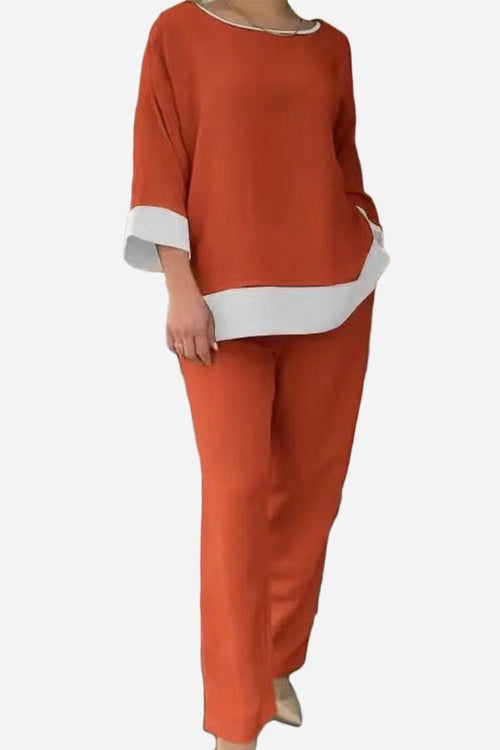 Orange dual-tone 3/4 sleeve two-piece set with contrasting white cuffs and hem, relaxed fit, cotton blend fabric.