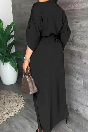 Black All-Day Drape Dress with cinched waist and front slit, breathable wrinkle-resistant polyester fabric.