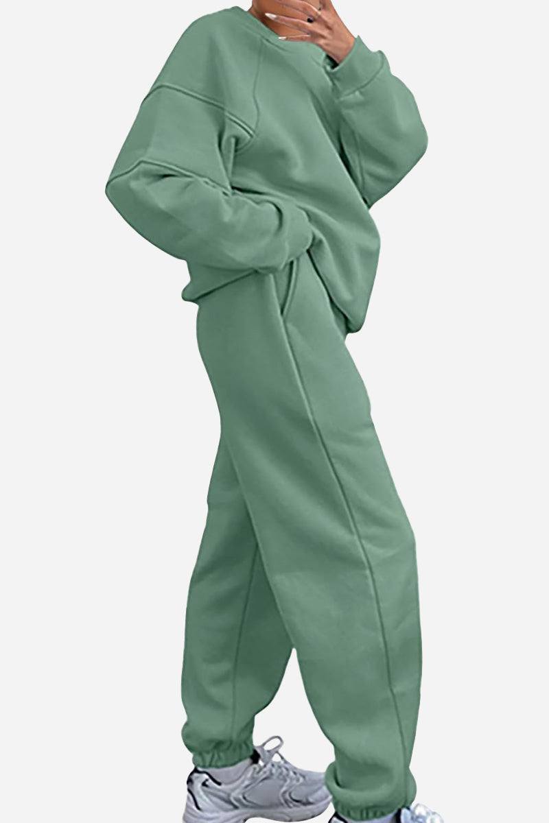 Comfy Chic Tracksuit in sage green polyester with relaxed fit, long sleeves, and roomy pockets.