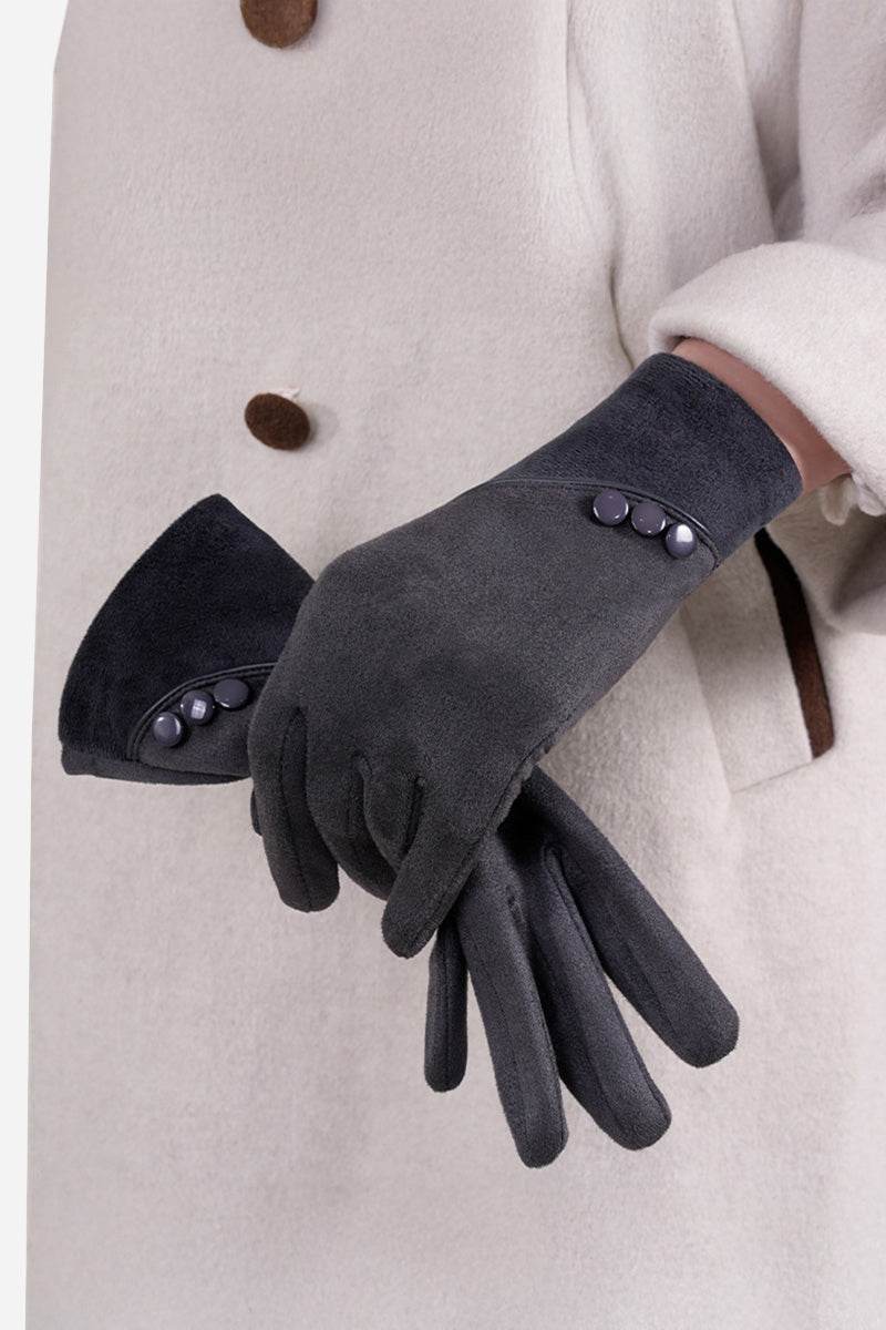 Black SmartTouch suede gloves with button detail worn over light-colored coat sleeve