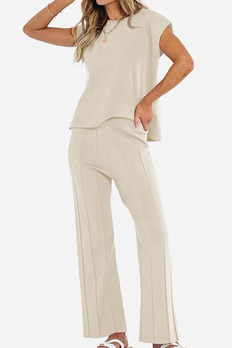 First Class Travel beige two-piece set with soft pleated pants and short sleeve top for stylish comfortable travel wear