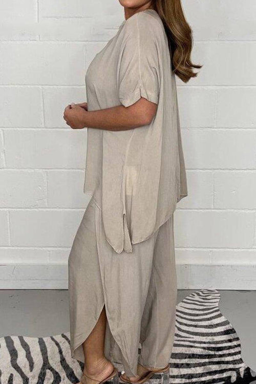 Relaxed linen-like travel two-piece set in beige with loose fit and side slits worn by woman