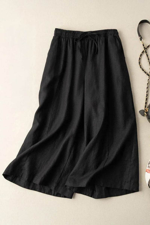 Black wide-leg cotton linen Tuscany trousers with elastic waistband and drawstring detail.
