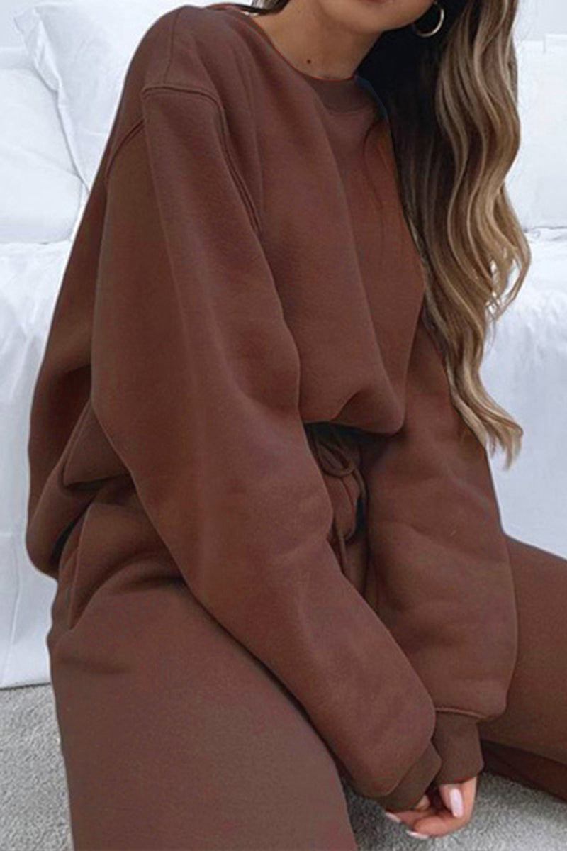 Women wearing brown Classic Comfort Athleisure set with long sleeves and relaxed fit sitting on bed
