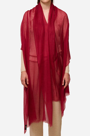 Lightweight red 100% cashmere featherlight luxury scarf worn as a wrap over beige outfit