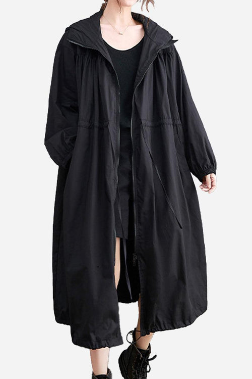 Black oversized all-weather water-resistant windbreaker with hood and drawstrings, styled for comfort and breathability in any weather