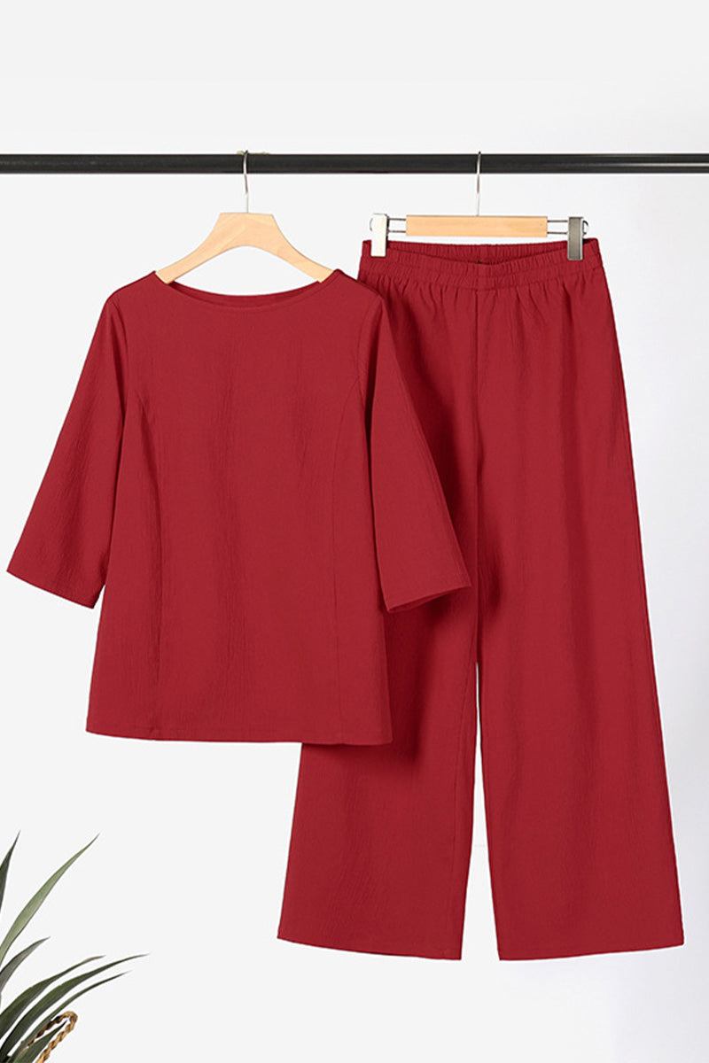 Elegant burgundy textured two-piece set with loose fit top and wide-leg pants on hangers