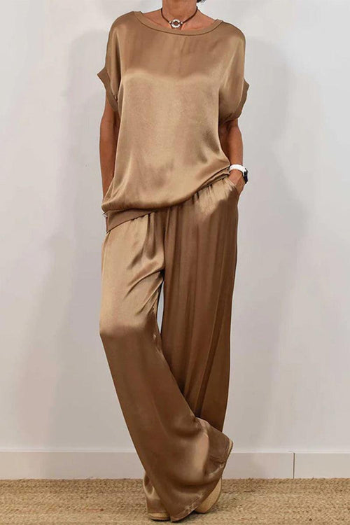 Woman wearing Silken Escape Satin Two-Piece Set in taupe with a relaxed fit and flowy wide-leg pants.