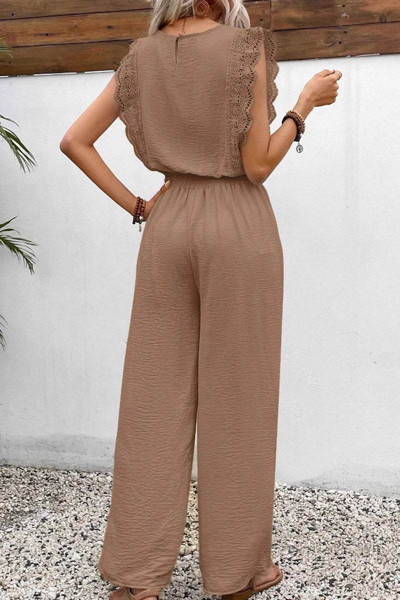 Woman wearing elegant two-piece set with lace detail in brown textured fabric, standing outdoors.