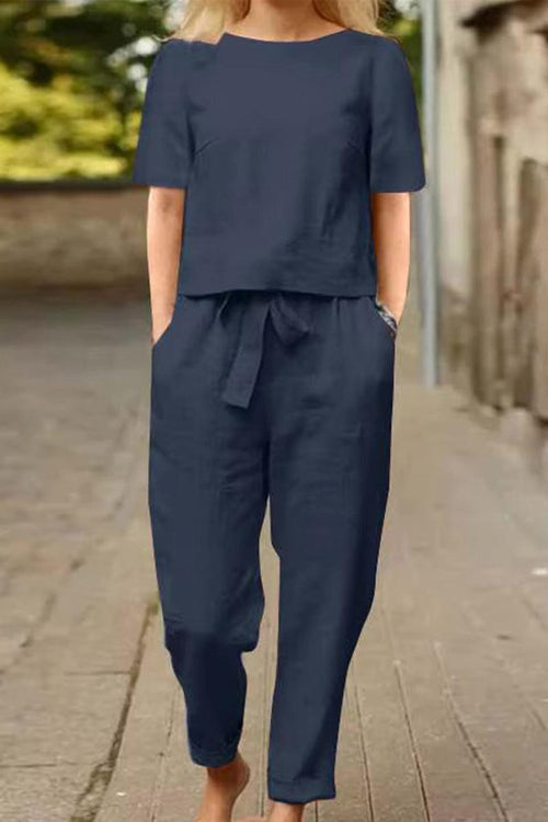 woman wearing navy cotton-linen blend monochrome two-piece set with relaxed fit and short sleeves on street background