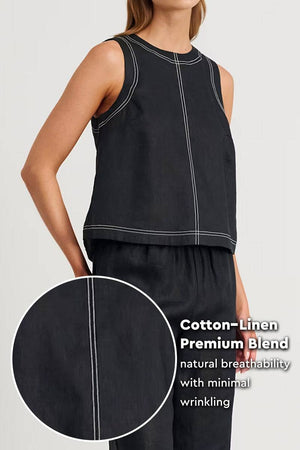 Woman wearing black cotton-linen relaxed back-slit two-piece set with white contrast stitching and natural breathable fabric.