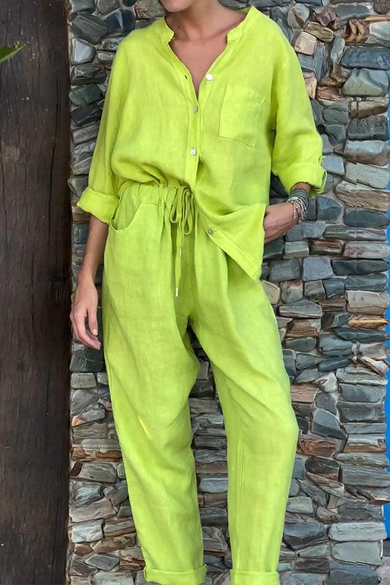 Lime green casual chic two-piece set with button-up top and drawstring pants against stone wall background