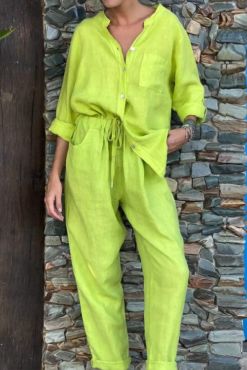 Lime green casual chic two-piece set with button-up top and drawstring pants against stone wall background