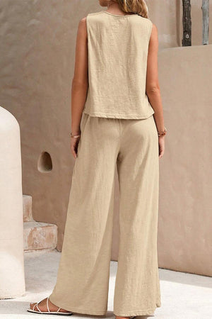 Woman wearing beige sleeveless wide leg pants set standing outdoors