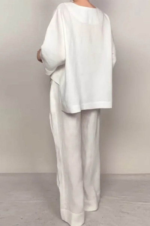 woman wearing white Atelier Serenity layered two-piece set with loose top and wide-leg pants back view